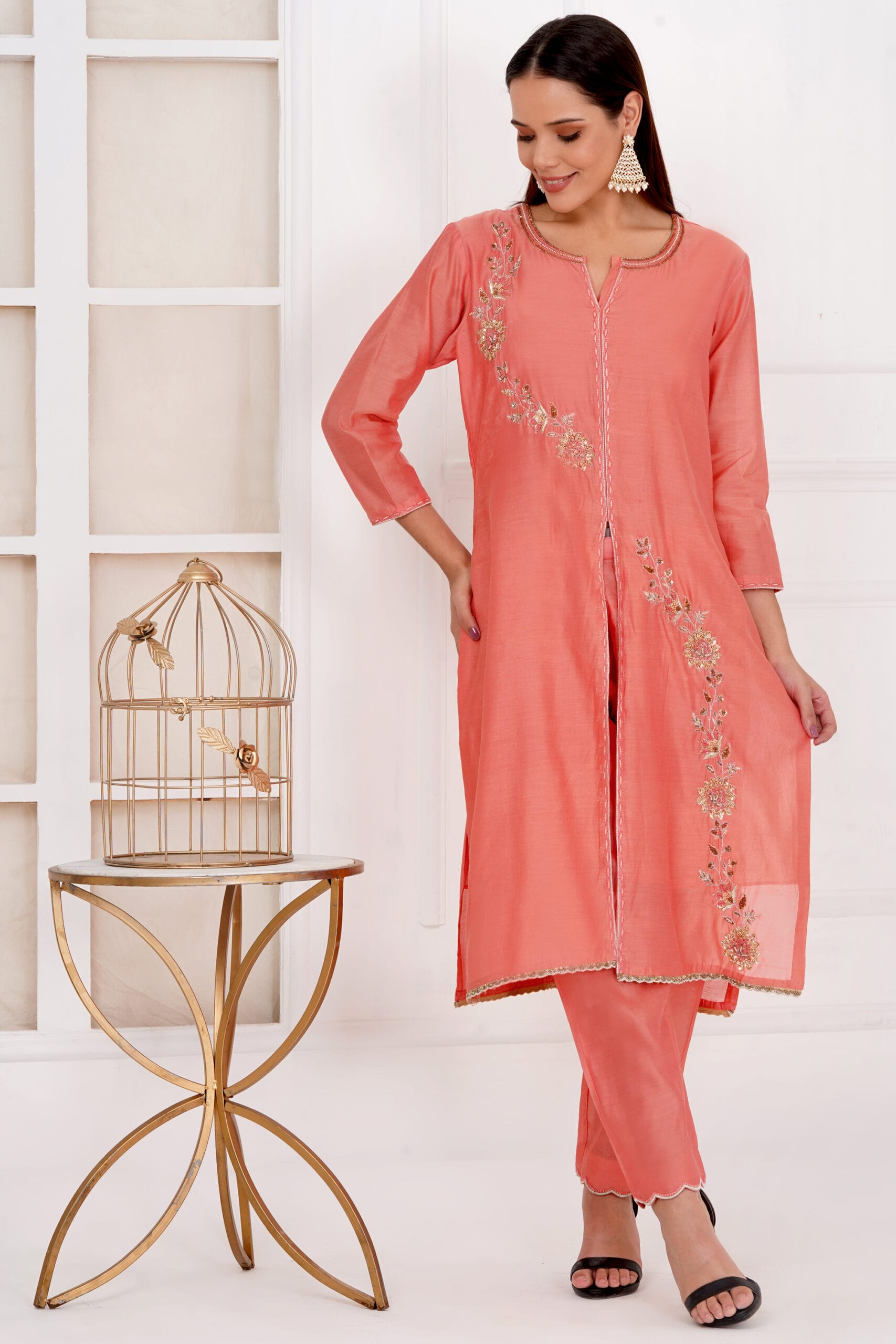Model wearing peach hand embroidery chanderi silk kurta pants set by House of vyana