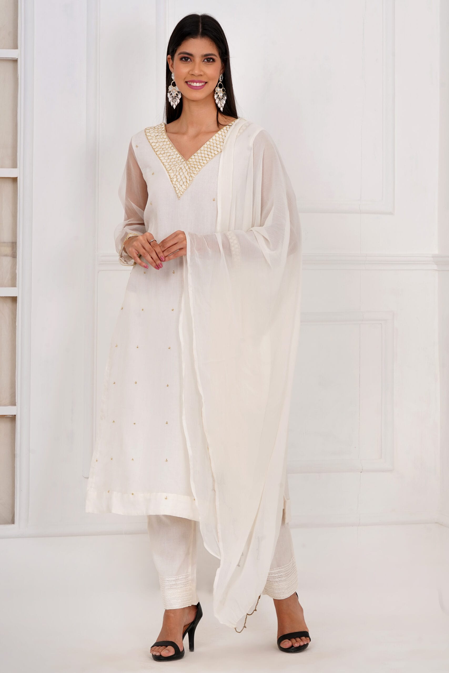 Hand-embroidered off-white kurta suit set featuring intricate craftsmanship. Made from premium fabric, this elegant traditional attire is perfect for weddings, festivals, and special occasions.