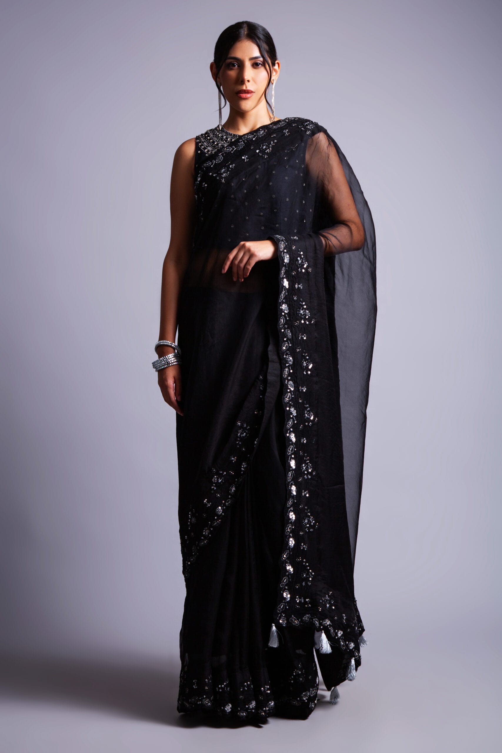 Black Organza Sari, adorned with intricate silver zari, silk thread, cutdana, and stone embellishments.